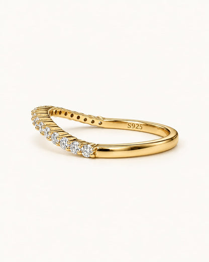 Gold curved moissanite contour band ring, angled view