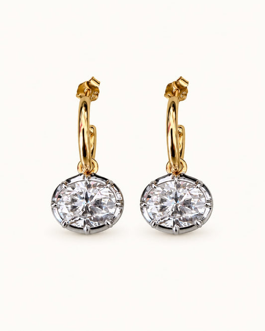 Forte oval moissanite bezel earrings with gold hoops and silver-tone pendants, front view of the pair